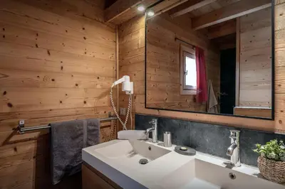 a bathroom with a sink and a mirror at Chalet Uska - OVO Network in Combloux