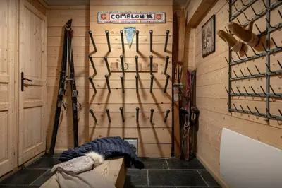 a room with a wall filled with ski equipment at Chalet Uska - OVO Network in Combloux