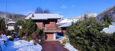 a log cabin in the snow with a road at Savoyard chalet 6pers exceptional view in Les Houches