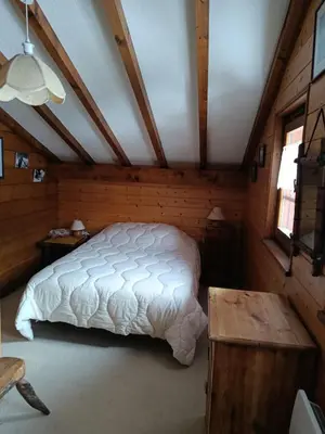 a bedroom with a white bed in a attic at Savoyard chalet 6pers exceptional view in Les Houches
