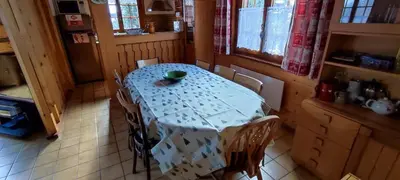 a table in a kitchen with a blue table cloth at Savoyard chalet 6pers exceptional view in Les Houches