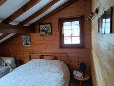 a bedroom with a bed in a wooden cabin at Savoyard chalet 6pers exceptional view in Les Houches