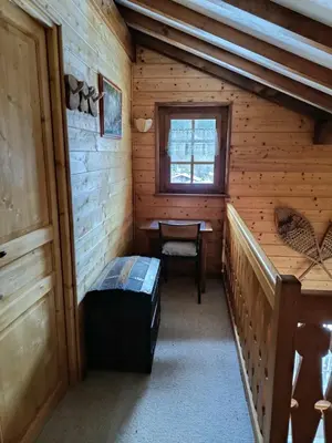 a room in a log cabin with a bed and a window at Savoyard chalet 6pers exceptional view in Les Houches