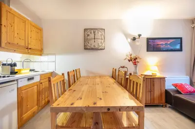 a kitchen and dining room with a wooden table at Gélinotte 23 - Station de ski à pied in Morillon