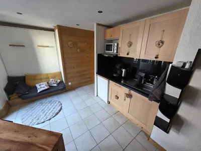 a kitchen with a couch in the middle of it at Chez l'Alpiniste - Chamonix Center in Chamonix-Mont-Blanc