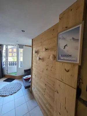 a room with a wooden wall with a sign on it at Chez l'Alpiniste - Chamonix Center in Chamonix-Mont-Blanc