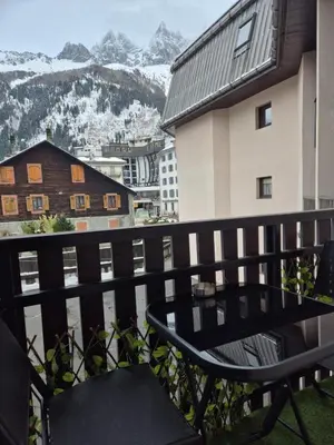 a large building with a balcony in the snow at Chez l'Alpiniste - Chamonix Center in Chamonix-Mont-Blanc