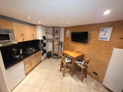 a kitchen with a table and a small table and chairs at Chez l'Alpiniste - Chamonix Center in Chamonix-Mont-Blanc