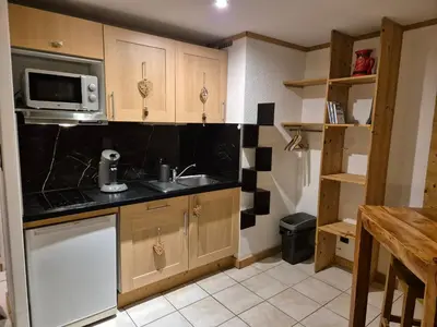 a kitchen with a sink and a microwave at Chez l'Alpiniste - Chamonix Center in Chamonix-Mont-Blanc