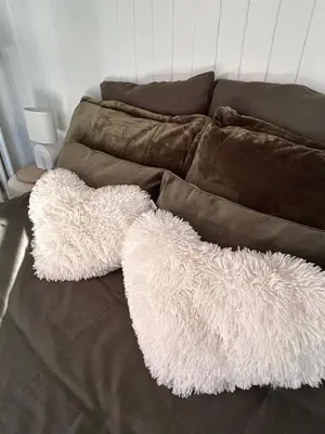 a couch with two white furry pillows on it at Panorama MB 356 - Grande maison familiale vue exceptionnelle in Sallanches