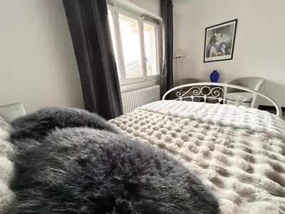 a bedroom with a bed with a furry blanket at Panorama MB 356 - Grande maison familiale vue exceptionnelle in Sallanches