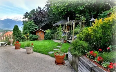 a garden with potted plants and a gazebo at Panorama MB 356 - Grande maison familiale vue exceptionnelle in Sallanches