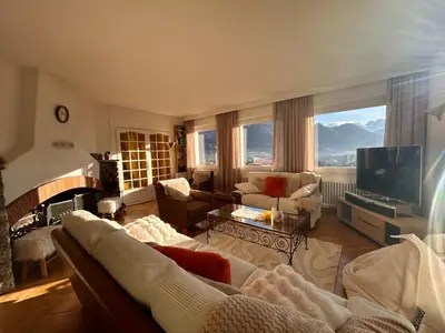 a living room with a couch and a television at Panorama MB 356 - Grande maison familiale vue exceptionnelle in Sallanches