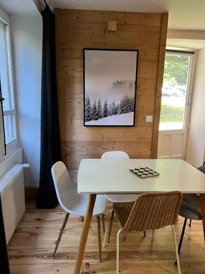 a dining room with a white table and chairs at Refuge du Lyret Cozy Central Chamonix, Garden, Pkg in Chamonix-Mont-Blanc