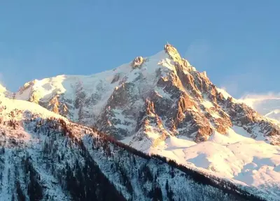 a mountain covered in snow with the sky in the background at Superbe T3- Vue Mont-Blanc- Au pied du Brévent- Chamonix in Chamonix-Mont-Blanc