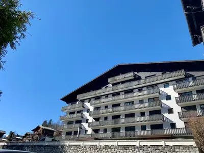 a white building with balconies on the side of it at Superbe T3- Vue Mont-Blanc- Au pied du Brévent- Chamonix in Chamonix-Mont-Blanc