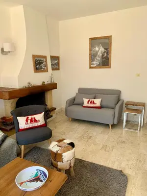 a living room with a couch and a chair at Superbe T3- Vue Mont-Blanc- Au pied du Brévent- Chamonix in Chamonix-Mont-Blanc