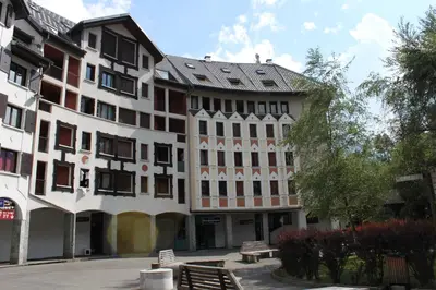 a building with benches in front of it at Apartment with terrace Gentianes 1 Centre Chamonix by Aiguille du Midi in Chamonix-Mont-Blanc