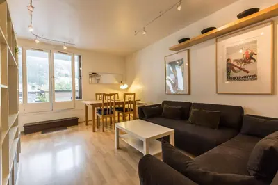 a living room with a couch and a table at Apartment with terrace Gentianes 1 Centre Chamonix by Aiguille du Midi in Chamonix-Mont-Blanc