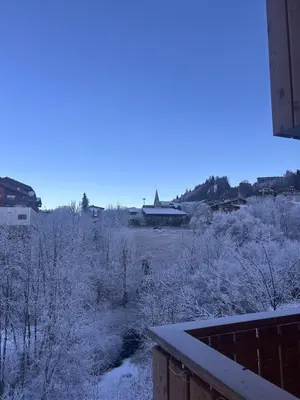 a snow covered field with a house in the background at Appartement standing 3 chambres, Luxury 3-bedroom apartment 75m2 in Arâches-la-Frasse