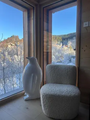 a vase sitting next to a chair in front of a window at Appartement standing 3 chambres, Luxury 3-bedroom apartment 75m2 in Arâches-la-Frasse