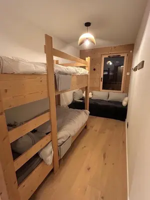 a room with two bunk beds and a couch at Appartement standing 3 chambres, Luxury 3-bedroom apartment 75m2 in Arâches-la-Frasse