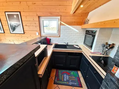 a small kitchen with a sink and a counter at Bel-Achat Vue MontBlanc in Chamonix-Mont-Blanc