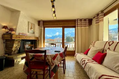 a living room with a table and a couch at Mont Blanc view and hiking trails in Combloux in Combloux