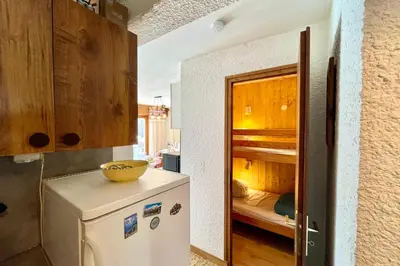 a kitchen with a refrigerator with a bowl on top at Mont Blanc view and hiking trails in Combloux in Combloux