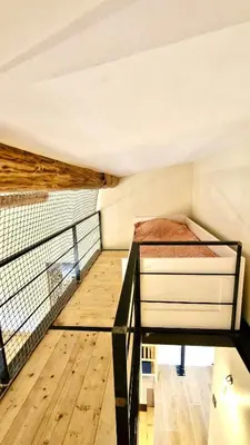 a small bedroom with a bed on a balcony at Cozy Bellevue - outdoor, skiing in Les Houches in Les Houches