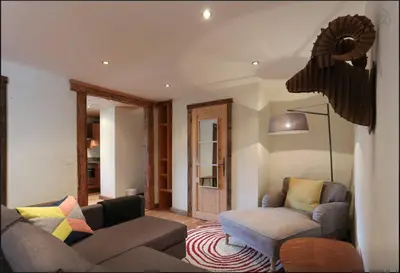a living room with a couch and a chair at Chamonix Apartment in Chamonix-Mont-Blanc
