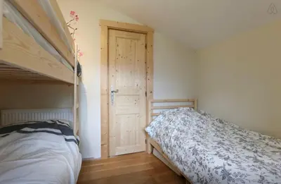 a bedroom with a bed and a bunk bed at Chamonix Apartment in Chamonix-Mont-Blanc