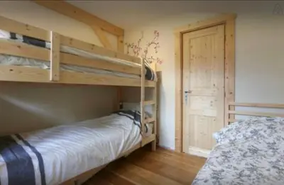 a bedroom with two bunk beds and a door at Chamonix Apartment in Chamonix-Mont-Blanc