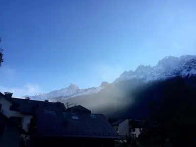 a misty mountain range with houses and mountains at Chamonix Apartment in Chamonix-Mont-Blanc