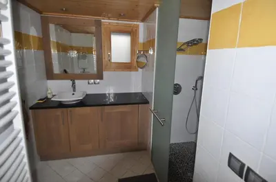 a bathroom with a sink and a mirror at Résidence Les Chardons Argentés in Samoëns