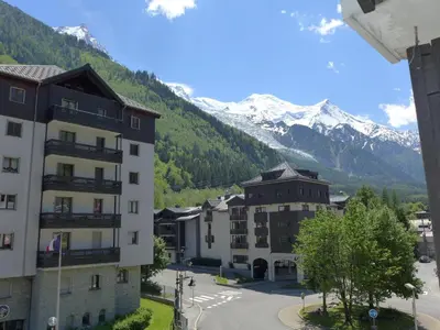 a view of a building with mountains in the background at Apartment Le Chamois Blanc-8 by Interhome in Chamonix-Mont-Blanc