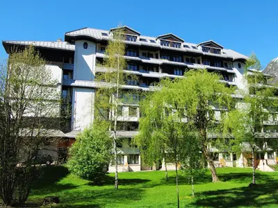 an apartment building with trees in front of it at Apartment Le Chamois Blanc-8 by Interhome in Chamonix-Mont-Blanc