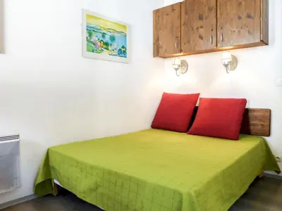 a room with a bed with two red pillows at Apartment Le Chamois Blanc-8 by Interhome in Chamonix-Mont-Blanc