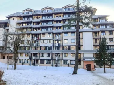 a large building with snow in front of it at Apartment Le Chamois Blanc-8 by Interhome in Chamonix-Mont-Blanc