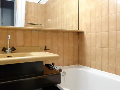 a bathroom with a sink and a bath tub at Apartment Le Chamois Blanc-8 by Interhome in Chamonix-Mont-Blanc