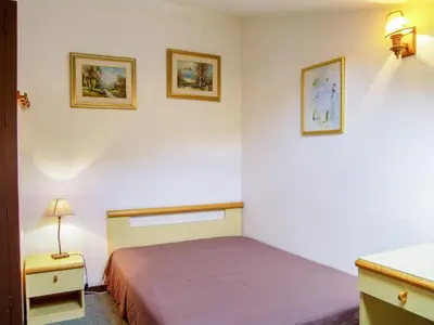 a bedroom with a bed and two pictures on the wall at Studio Le Triolet-6 by Interhome in Chamonix-Mont-Blanc