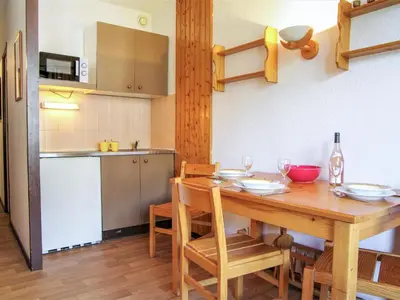 a kitchen and dining room with a wooden table at Studio Le Triolet-6 by Interhome in Chamonix-Mont-Blanc
