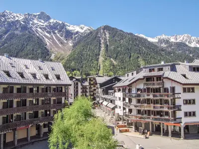 a group of buildings in front of a mountain at Studio Gentiane-5 by Interhome in Chamonix-Mont-Blanc