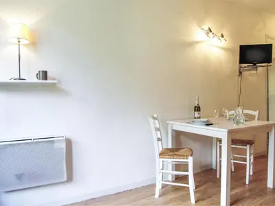 a room with a table and chairs and a tv at Studio La Forclaz-6 by Interhome in Chamonix-Mont-Blanc