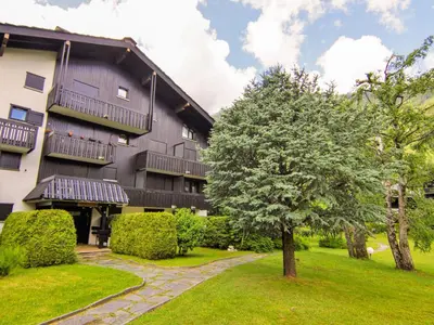 a building with a tree in front of it at Studio Champraz-14 by Interhome in Chamonix-Mont-Blanc
