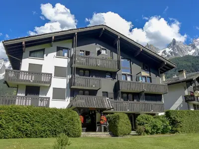 a small kitchen with a table and two chairs at Studio Champraz-14 by Interhome in Chamonix-Mont-Blanc