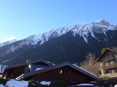an empty road with a gate and a garage at Apartment Clos des Outannes-1 by Interhome in Chamonix-Mont-Blanc