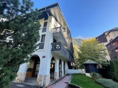 a white building with a balcony on the side of it at Apartment Le Triolet-5 by Interhome in Chamonix-Mont-Blanc