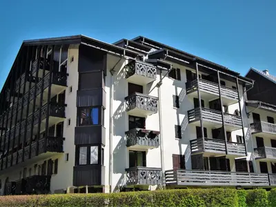 a view of a mountain with trees and a building at Apartment Le Triolet-5 by Interhome in Chamonix-Mont-Blanc