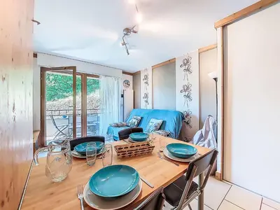a bedroom with a blue bed with pillows on it at Apartment Clos de la fontaine 2 by Interhome in Saint-Gervais-les-Bains
